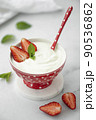 fresh homemade greek yogurt with strawberries in a red bowl 90536862