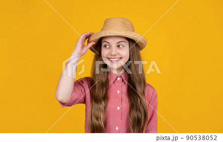 happy teen girl in straw hat on yellow background 90538052