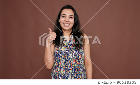 Portrait of indian woman doing thumbs up gesture on camera, giving like and approval to idea. Cool optimistic okay symbol with satisfaction and positivity, successful agreement. 90538305