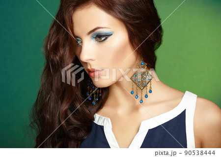 Portrait of beautiful brunette woman with earring. Perfect makeup Portrait of beautiful brunette woman with earring. Perfect makeup 90538444