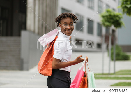 Portrait of beautiful young African American woman, wearing casual clothes, going for shopping. 90538485