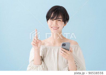 スマホを持つ女性　水色　青 90538556