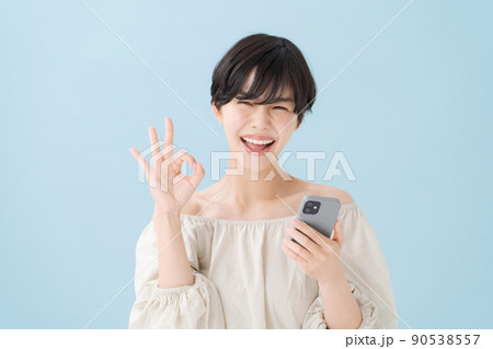 スマホを持つ女性　水色　青 90538557