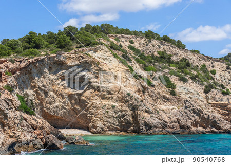 Part of steep coast, layers of centuries-old rock are clearly visible 90540768