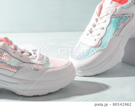 White pastel sneakers with sequins on geometric podiums on turquoise White pastel sneakers with sequins on geometric podiums on turquoise 90542962