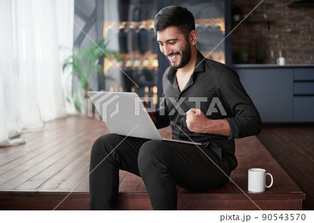 happy business owner looking at his laptop screen. happy business owner looking at his laptop screen. 90543570
