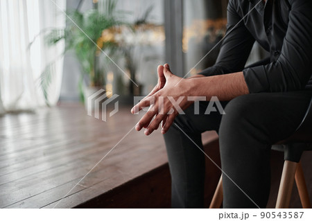 cropped image of a thoughtful owner sitting in his new store. 90543587