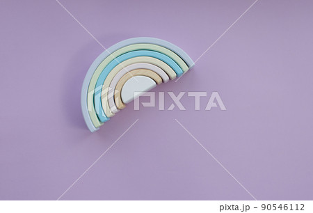 Children's wooden eco-friendly toys. A semicircle. Color Rainbow Colors: blue, light green, dark white on a gray background. View from above 90546112