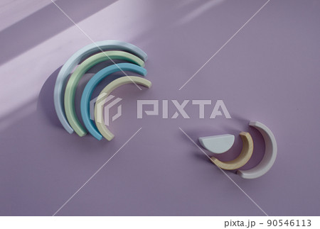 Children's wooden eco-friendly toys. A semicircle. Color Rainbow Colors: blue, light green, dark white on a gray background. View from above Children's wooden eco-friendly toys. A semicircle. Color Rainbow Colors: blue, light green, dark white on a gray background. View from above 90546113