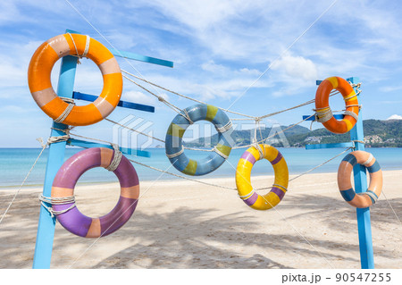 Artificial swim ring rubber on the beach with blue sky in summer at Patong Beach, Phuket Island, Thailand. 90547255