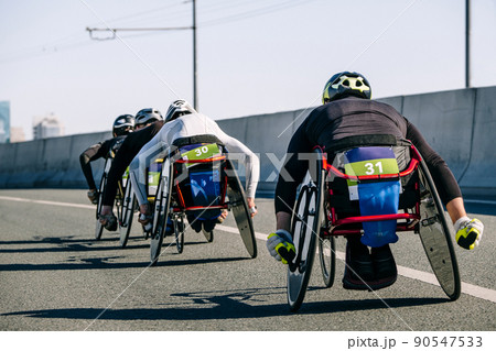 back group wheelchair athlete in marathon race 90547533