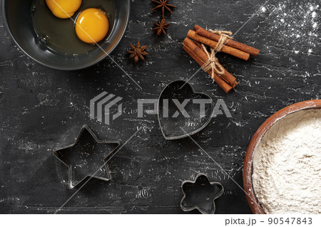 Preparation for baking. Eggs and flour on black background 90547843