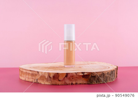 Cosmetic liquid foundation nude cream bottle mockup on wooden podium. Beige concealer base cosmetics product mock up on pink background. Skincare beauty primer Cosmetic liquid foundation nude cream bottle mockup on wooden podium. Beige concealer base cosmetics product mock up on pink background. Skincare beauty primer 90549076
