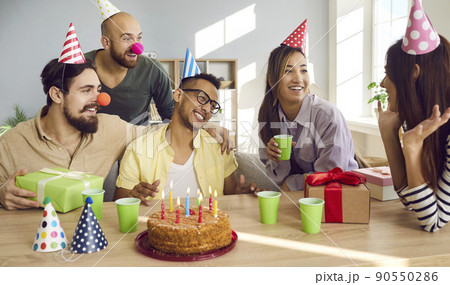 Happy diverse friends celebrate birthday with cake 90550286