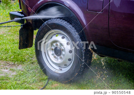 Car wash in the afternoon outdoors with a high-pressure apparatus.  90550548
