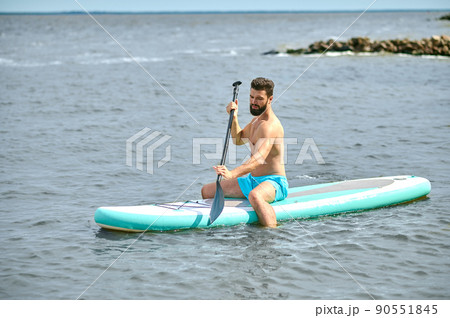 A dark-haired young man on a kayak A dark-haired young man on a kayak 90551845
