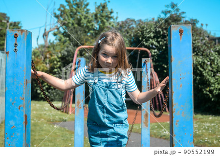 Six years old child girl happy face. Summer holidays. Close up portrait of little kid on playground. Happy smiling joyful child, true emotion, carefree childhood concept. 90552199
