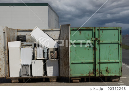 Electronic waste for recycling. Discarded household appliances in the garbage container 90552248