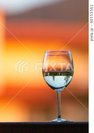 white wine glass on the sunset blur background white wine glass on the sunset blur background 90553561