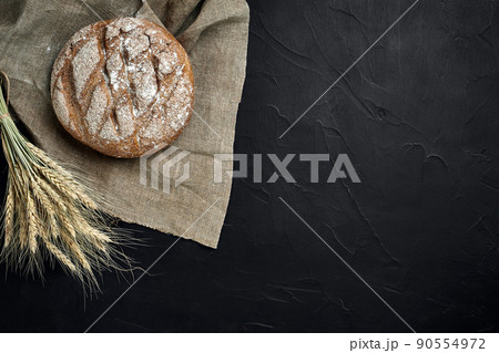 Freshly baked bread on dark kitchen table, top view 90554972