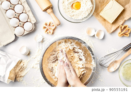 Baker preparing to knead the dough, top view. Cooking, bakery concept Baker preparing to knead the dough, top view. Cooking, bakery concept 90555191