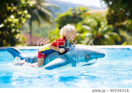 Child in swimming pool. Kid on inflatable float Child in swimming pool. Kid on inflatable float 90556318