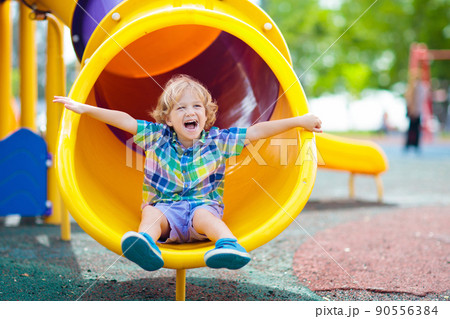 Child on playground. Kids play outdoor. Child on playground. Kids play outdoor. 90556384