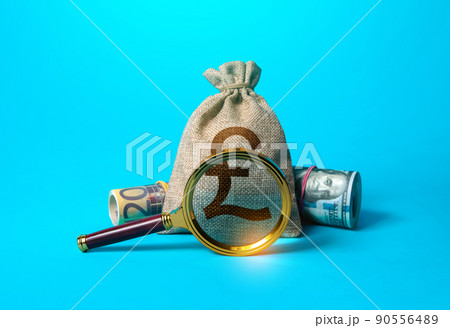 British pound sterling money bag and magnifying glass. Anti money laundering, tax evasion. Deposit or loan terms conditions. Find investment funds for business project. Investigating capital origins. 90556489