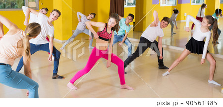 Tweens exercising with coach in choreography class Tweens exercising with coach in choreography class 90561385