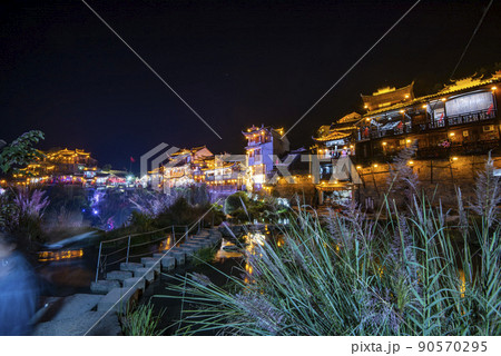 Furong Ancient Town illuminated at night. Amazing beautiful landscape scene of Furong Ancient Town (Furong Zhen, Hibiscus Town), China 90570295