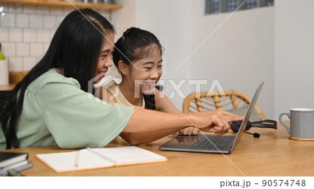 Cute asian girl with mother doing homework at home. Education and school concept Cute asian girl with mother doing homework at home. Education and school concept 90574748