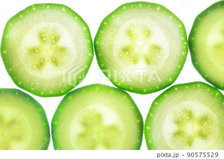 Slices of zucchini isolated on white Slices of zucchini isolated on white 90575529