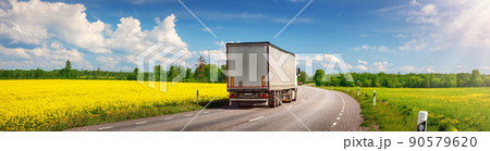 Truck moving on the asphalt country highway in sunny day in spring. 90579620