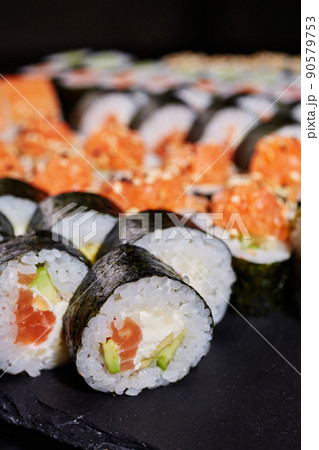 Maki rolls stuffed with salmon, avocado and cream cheese. 90579753