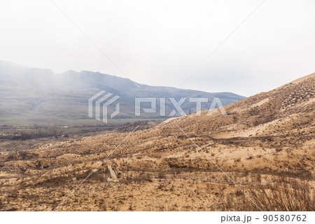 A unique sandy mountain in the Caucasus on a cloudy day. A unique sandy mountain in the Caucasus on a cloudy day. 90580762