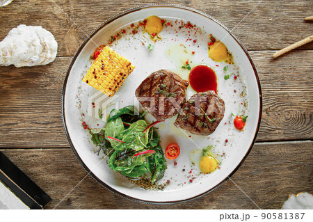 Portion of grilled fillet mignon steak with corn Portion of grilled fillet mignon steak with corn 90581387