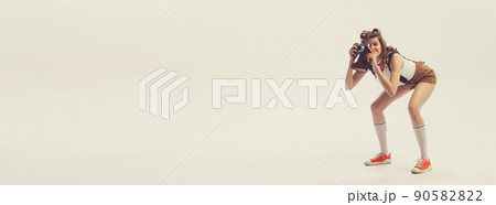 Young beautiful charming girl retro, 70s, 80s fashion style clothes, vintage outfit posing isolated on white background. Concept of art, fashion, beauty, emotions Young beautiful charming girl retro, 70s, 80s fashion style clothes, vintage outfit posing isolated on white background. Concept of art, fashion, beauty, emotions 90582822
