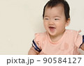 girl baby smiles on the white background 90584127