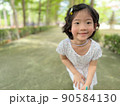 cute little girl smile with beautiful pose in the garden with copy space 90584130
