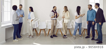 Group of young people meeting and communicating at a business event in the office Group of young people meeting and communicating at a business event in the office 90584916