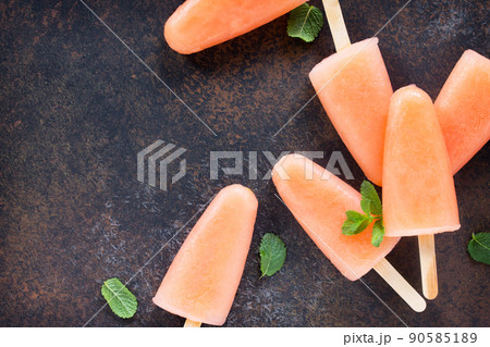 Delicious fruit ice grapefruit and mint on a stone background. Top view with copy space. 90585189