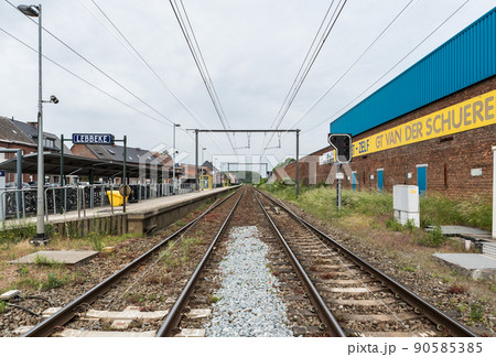 Lebbeke, Flanders - Belgium - Empty railway tracks and platform of the Lebbeke station at the Belgian countryside 90585385