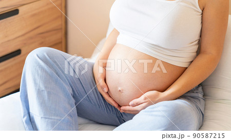 Pregnancy yoga meditation. Health yoga home sport. Beautiful pregnant woman meditating while sitting in lotus position. Concept maternity, pregnancy, childbirth. Pregnancy yoga meditation. Health yoga home sport. Beautiful pregnant woman meditating while sitting in lotus position. Concept maternity, pregnancy, childbirth. 90587215