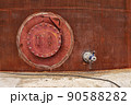 Opened rusty manhole on the fuel tank shell storage tank 90588282