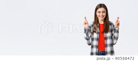 Lifestyle, different emotions, leisure activities concept. Hopeful cute caucasian girl in checked shirt, making wish, cross fingers good luck and smiling optimistic, white background Lifestyle, different emotions, leisure activities concept. Hopeful cute caucasian girl in checked shirt, making wish, cross fingers good luck and smiling optimistic, white background 90588472