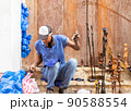 artisan carving wood in the street with his works of art 90588554