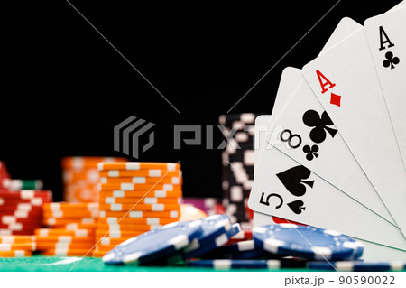 Poker chips and playing cards on black background 90590022
