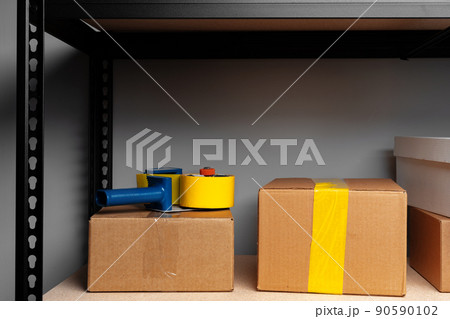 Rack shelves with paper boxes in warehouse. 90590102