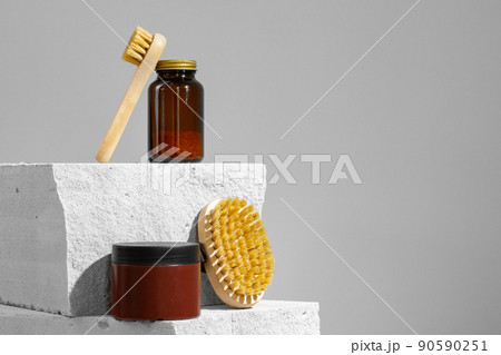 Skincare cosmetics and massage brush on grey background 90590251
