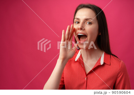 Portrait of young woman shouting over pink background Portrait of young woman shouting over pink background 90590604